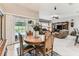 Open dining area with antique furniture and sliding glass door to the pool at 11009 Wildcat Dr, Riverview, FL 33579
