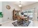 Bright dining area with antique furniture and a view of the backyard pool at 11009 Wildcat Dr, Riverview, FL 33579