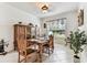 Bright dining room features tile floors, classic decor, and natural light from the window at 11009 Wildcat Dr, Riverview, FL 33579