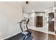 Indoor workout area, including a treadmill and hardwood floors at 11009 Wildcat Dr, Riverview, FL 33579