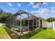 Rear exterior view features a screened in pool and fenced in backyard on a sunny day at 11009 Wildcat Dr, Riverview, FL 33579