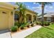 Exterior home detail showcasing landscaped walkway with lush greenery and columns at 11009 Wildcat Dr, Riverview, FL 33579