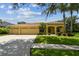 Charming single-story home featuring a three-car garage, manicured lawn, and tropical landscaping at 11009 Wildcat Dr, Riverview, FL 33579