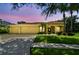 Charming yellow single story home with a three car garage and mature landscaping at 11009 Wildcat Dr, Riverview, FL 33579