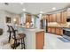 Bright kitchen featuring wood cabinets, stainless steel appliances, and granite countertops at 11009 Wildcat Dr, Riverview, FL 33579