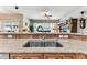 Kitchen with stainless steel sink and tile backsplash opening into the living area at 11009 Wildcat Dr, Riverview, FL 33579