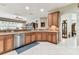 Modern kitchen features stainless steel appliances, wooden cabinets, and tile countertops at 11009 Wildcat Dr, Riverview, FL 33579