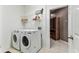 Well-organized laundry room with modern washer and dryer and shelving for storage at 11009 Wildcat Dr, Riverview, FL 33579