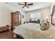 Spacious bedroom with ample natural light, ceiling fan, and elegant wood furniture at 11009 Wildcat Dr, Riverview, FL 33579