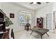 Well-lit office space with neutral tones, decorative globe, and view to the exterior at 11009 Wildcat Dr, Riverview, FL 33579