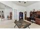 Home office with tiled floor, neutral walls, and a large slate coffee table at 11009 Wildcat Dr, Riverview, FL 33579