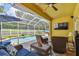 Covered patio offers ample seating and views of the screened pool and fenced backyard at 11009 Wildcat Dr, Riverview, FL 33579