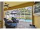 Covered patio with comfortable seating, a ceiling fan, and a view of the screened pool at 11009 Wildcat Dr, Riverview, FL 33579