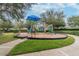 Well-maintained playground featuring modern play structures, surrounded by lush green grass and mature shade trees for Gathering enjoyment at 11009 Wildcat Dr, Riverview, FL 33579