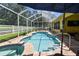 Enclosed screened pool features a spa and brick pavers, creating a private outdoor oasis at 11009 Wildcat Dr, Riverview, FL 33579