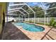 Beautiful pool area with a screened enclosure, patio furniture, and a serene backyard view at 11009 Wildcat Dr, Riverview, FL 33579