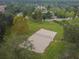 Overhead shot of a sand volleyball court in a well-maintained, green common area for community enjoyment at 11009 Wildcat Dr, Riverview, FL 33579