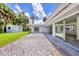This backyard features a modern patio, lush lawn, storage shed, and seamless transition to the home's interior at 116 Myakka Dr, Venice, FL 34293