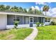 Charming home with a screened-in porch, and a well-manicured front lawn at 116 Myakka Dr, Venice, FL 34293