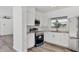Modern kitchen boasts stainless steel appliances, white cabinets and a view of the outdoors at 116 Myakka Dr, Venice, FL 34293