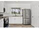Bright kitchen features stainless steel appliances, white cabinetry and a large window for natural light at 116 Myakka Dr, Venice, FL 34293