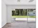 Bright living room features modern flooring and a sliding glass door leading to a green outdoor area at 116 Myakka Dr, Venice, FL 34293