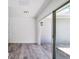 Open-concept living room features modern flooring and a large sliding glass door for natural light at 116 Myakka Dr, Venice, FL 34293