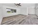 Bright living room with modern floors, large windows, and white brick accent wall at 116 Myakka Dr, Venice, FL 34293