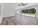 Modern living area with sleek floors, a ceiling fan, and large sliding glass doors at 116 Myakka Dr, Venice, FL 34293