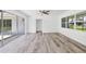 Spacious living room with sliding glass doors, new floors, and a modern ceiling fan at 116 Myakka Dr, Venice, FL 34293