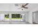 Living room with sleek flooring, modern ceiling fan, and access to the outdoor area at 116 Myakka Dr, Venice, FL 34293