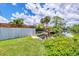 Waterfront backyard with boat dock access, surrounded by greenery, and complemented by a well-maintained lawn at 116 Myakka Dr, Venice, FL 34293