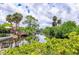A serene waterfront view featuring a private dock, lush greenery, and inviting canal access, great for boaters at 116 Myakka Dr, Venice, FL 34293