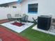 Backyard patio with seating area next to the AC unit and perimeter fence at 1209 Croydonwood Cir, Brandon, FL 33510