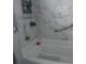 Clean bathroom showcasing a white tub with a showerhead and marble-style tiling at 1209 Croydonwood Cir, Brandon, FL 33510