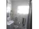Well-lit bathroom features a gray vanity, modern fixtures, and marbled walls at 1209 Croydonwood Cir, Brandon, FL 33510