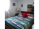 Bedroom featuring a striped bedspread, nightstand and lamp at 1209 Croydonwood Cir, Brandon, FL 33510