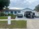 Well-maintained home featuring a tidy front yard, manicured lawn, and a charming fountain feature at 1209 Croydonwood Cir, Brandon, FL 33510