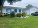 Well-maintained home featuring a tidy front yard, manicured lawn, and a charming fountain feature at 1209 Croydonwood Cir, Brandon, FL 33510