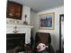 Living room fireplace with decorative mantle, flanked by art and comfortable seating at 1209 Croydonwood Cir, Brandon, FL 33510