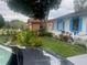 Front yard featuring a well-maintained lawn and colorful flowerbeds at 1209 Croydonwood Cir, Brandon, FL 33510