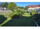 Lush front yard featuring vibrant flower beds, mature trees, and manicured lawn at 1209 Croydonwood Cir, Brandon, FL 33510