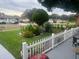 Beautiful front yard with lush landscaping, a white picket fence, and a tranquil ambiance at 1209 Croydonwood Cir, Brandon, FL 33510