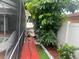 Outdoor scene with lush landscaping and a red brick walkway at 1209 Croydonwood Cir, Brandon, FL 33510
