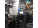 Efficient laundry room with modern, gray washing machines and ample storage shelves at 1209 Croydonwood Cir, Brandon, FL 33510