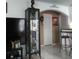 Living area featuring a display cabinet, tiled flooring, and an arched entryway at 1209 Croydonwood Cir, Brandon, FL 33510