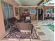 A covered patio area with wicker furniture, tile flooring, and a view of the pool at 1209 Croydonwood Cir, Brandon, FL 33510