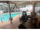 A covered and screened pool area with stylish outdoor seating and palm trees at 1209 Croydonwood Cir, Brandon, FL 33510