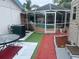 Backyard pool with a screen enclosure, adjacent to an AC unit and outdoor seating at 1209 Croydonwood Cir, Brandon, FL 33510