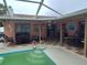 Screened-in swimming pool with lounge area, patio seating, and a view of the backyard at 1209 Croydonwood Cir, Brandon, FL 33510